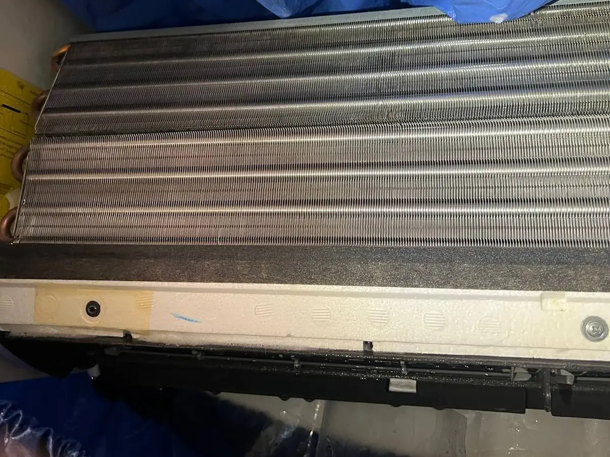 The same coil after washing, bare aluminum fins bright and open.